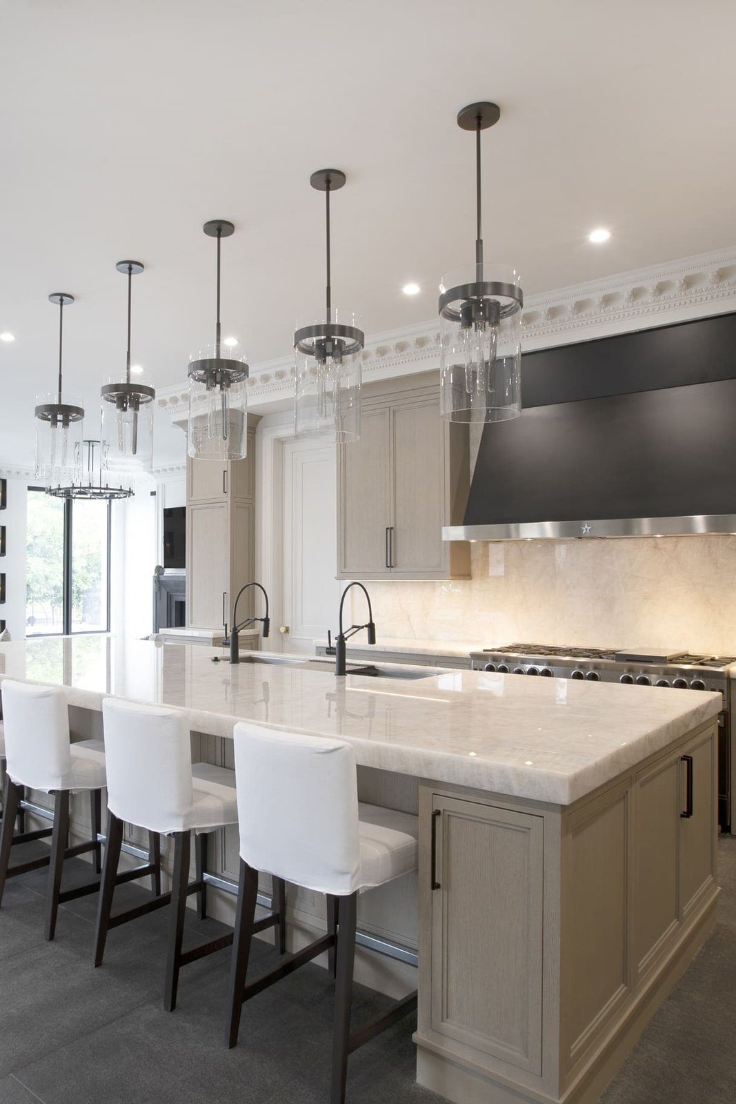 Cristallo Polished Cristallo quartzite island and backsplash in a designer’s kitchen